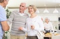 Two elderly couples warmly welcome each other as they gather for a festive holiday dinner in home Royalty Free Stock Photo