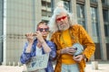 Two elderly hippy men encouraging people for donating love