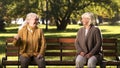 Two elderly ladies laughing and talking, sitting on bench in park, old friends Royalty Free Stock Photo