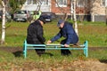 Two elderly men playing checkers on a street in Vidnoe Royalty Free Stock Photo