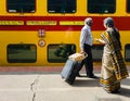 Two elderly passengers at a railway station