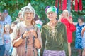 Two elderly sports women chat in the park at a flower festival