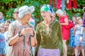 Two elderly sports women chat in the park at a flower festival