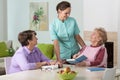 Two elderly women and a friendly nurse Royalty Free Stock Photo