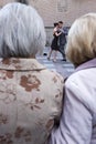 Two elderly women looking at tango dancers