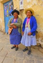 Two elderly women standing on sidewalk