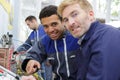 Two electrician workers at wiring cable and light switch