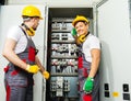 Two electricians on a factory