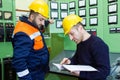electricians with yellow helmet working in a power station Royalty Free Stock Photo