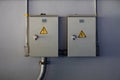 Two electricity cabinet with warning sign on the wall. Royalty Free Stock Photo