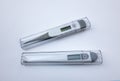 Two electronic thermometers on white isolate