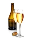 Two elegant glasses of champagne on the background of brown bottles close-up isolated on a white. Festive still life.