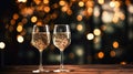 Two elegant glasses of champagne or sparkling wine Prosecco on a dark background with golden bokeh. Holiday concept Royalty Free Stock Photo