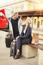 Two elegant woman with suitcase meeting on the railway station Royalty Free Stock Photo