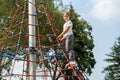 Two elementary school age kids, children climbing a tall structure at the playground together, exercise, healthy physical activity Royalty Free Stock Photo