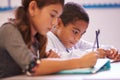 Two elementary school pupils working at desk during a lesson Royalty Free Stock Photo