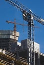 Two elevating cranes at the construction site Royalty Free Stock Photo