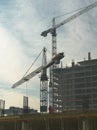 Two elevating cranes Royalty Free Stock Photo