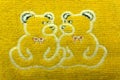 Two embroideries in decorative frames, accessories for embroidery, and Teddy bear`s toy on wooden background