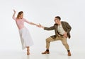 Two emotional dancers in vintage style clothes dancing swing dance, rock-and-roll or lindy hop isolated on white