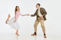 Two emotional dancers in vintage style clothes dancing swing dance, rock-and-roll or lindy hop isolated on white