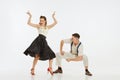 Two emotional dancers in vintage style clothes dancing swing dance, rock-and-roll or lindy hop on white