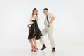 Two emotional dancers in vintage style clothes dancing swing dance, rock-and-roll or lindy hop on white