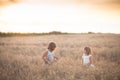 Two emotional sisters girls dance at sunset