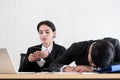 Two employees have lazy and playing the phone and sleep at the office in a relaxing time