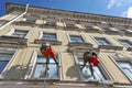 Two employees suspended at a height of washing Windows