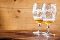 Two emptied glasses of beer on a counter