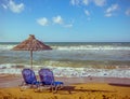 Two empty beach chair with umbrella