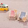 Two empty beach chairs in the sand, with old van Royalty Free Stock Photo