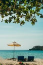 Two empty beach chairs and umbrella at a beach in Koh Kood, Thailand. Amazing scenery, relaxing beach, tropical landscape Royalty Free Stock Photo