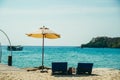 Two empty beach chairs and umbrella at a beach in Koh Kood, Thailand. Amazing scenery, relaxing beach, tropical landscape Royalty Free Stock Photo