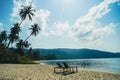 Two empty beach chairs and umbrella at a beach in Koh Kood, Thailand. Amazing scenery, relaxing beach, tropical landscape Royalty Free Stock Photo