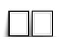 Two empty black picture frames on a white wall Royalty Free Stock Photo