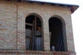 Two empty black windows on a brown brick wall of an unfinished house Royalty Free Stock Photo