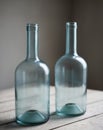 Two empty blue bottles sitting on top of a table. Royalty Free Stock Photo
