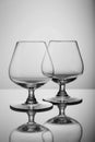 Two empty brandy glasses on white background