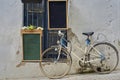 Two empty bulletin boards hanging on a wall next to an old bicycle Royalty Free Stock Photo