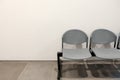 Two empty chairs by concrete wall background with copy space Royalty Free Stock Photo