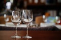 two empty clean wine glasses on a wooden table. utensils for alcoholic beverages