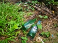 Two empty consumed Heineken beer bottle was found or thrown on the bushes Royalty Free Stock Photo