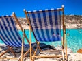 Two empty deck chairs and sea at backgroung Royalty Free Stock Photo