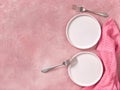 Two empty dessert plates, forks and napkin on pink concrete background Royalty Free Stock Photo