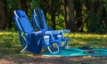 Two empty folding chair on the green grass on a sunny day. Two chairs for a picnic in the summer park Royalty Free Stock Photo