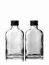 Two empty glass russian vodka bottle with black cap isolated on a white background Royalty Free Stock Photo