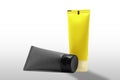 Two Empty Lotion Tubes Plastic Makeup Squeeze Tube Refillable Cream Bottles yellow and gray packaging Royalty Free Stock Photo