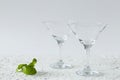 Two empty martini glasses of cocktail on white background. Royalty Free Stock Photo